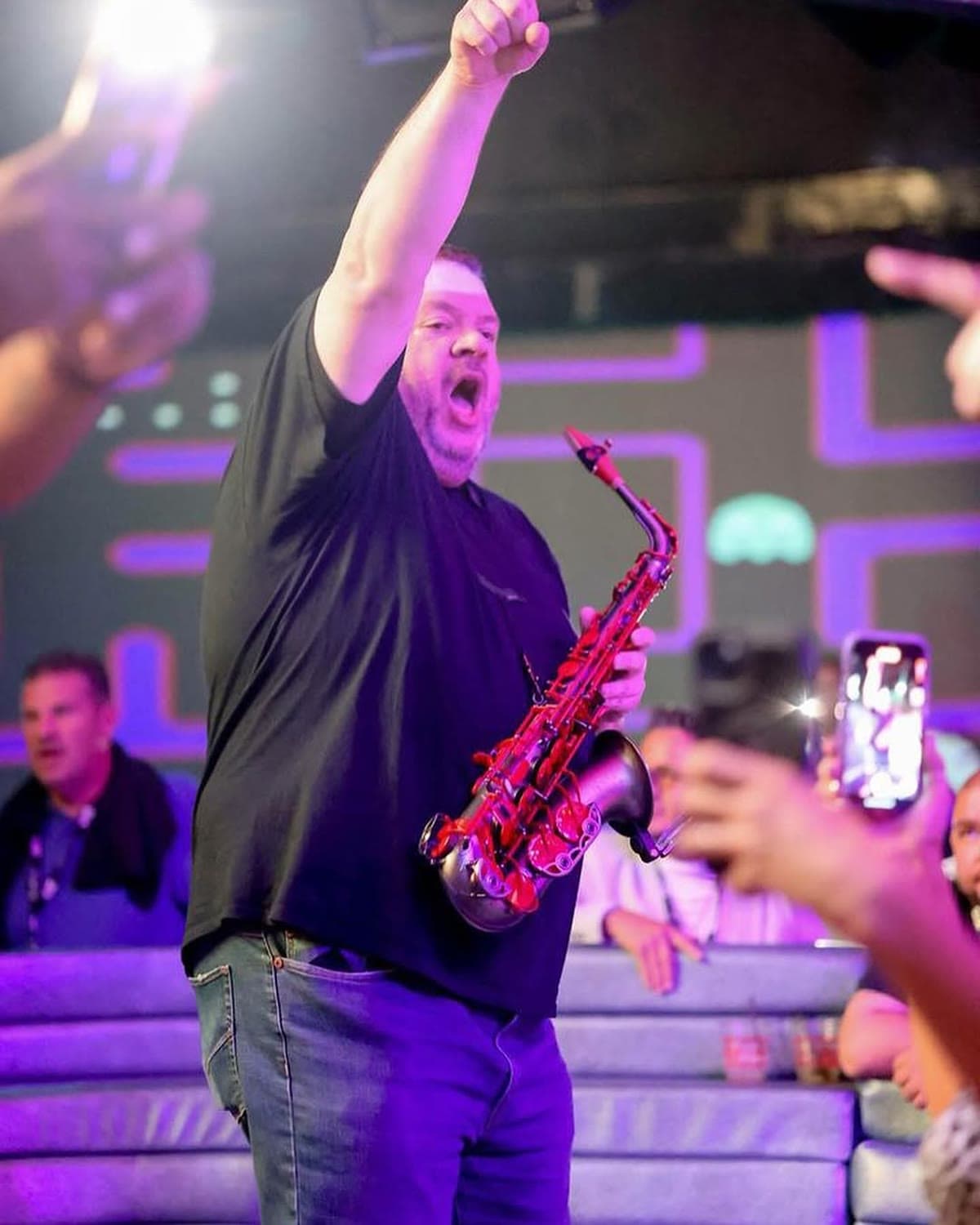 Guests reacting to live sax performance